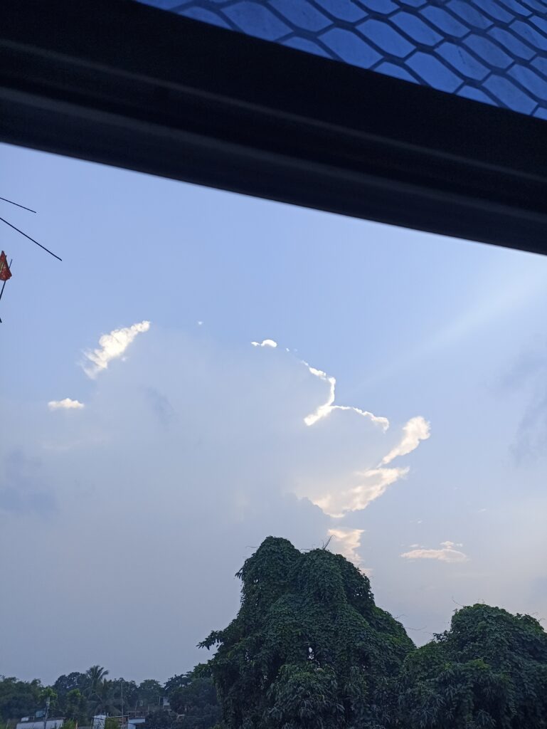 Massive rain cloud building over a residential neighbourhood on the Indo–Nepal border.
