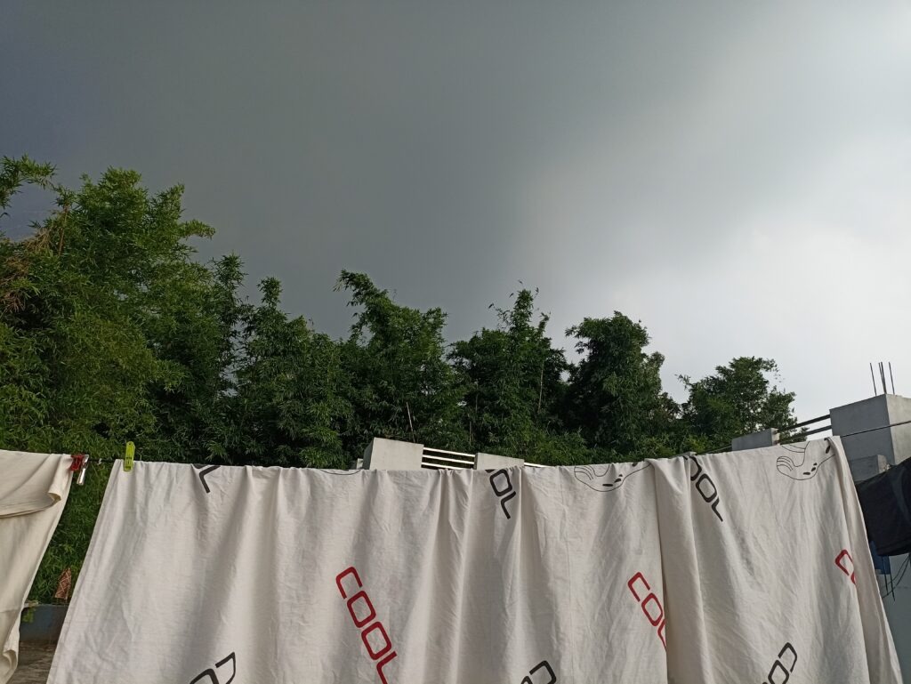 The dark clouds seemed to hang low above the green bamboo and trees surrounding our neighbourhood.