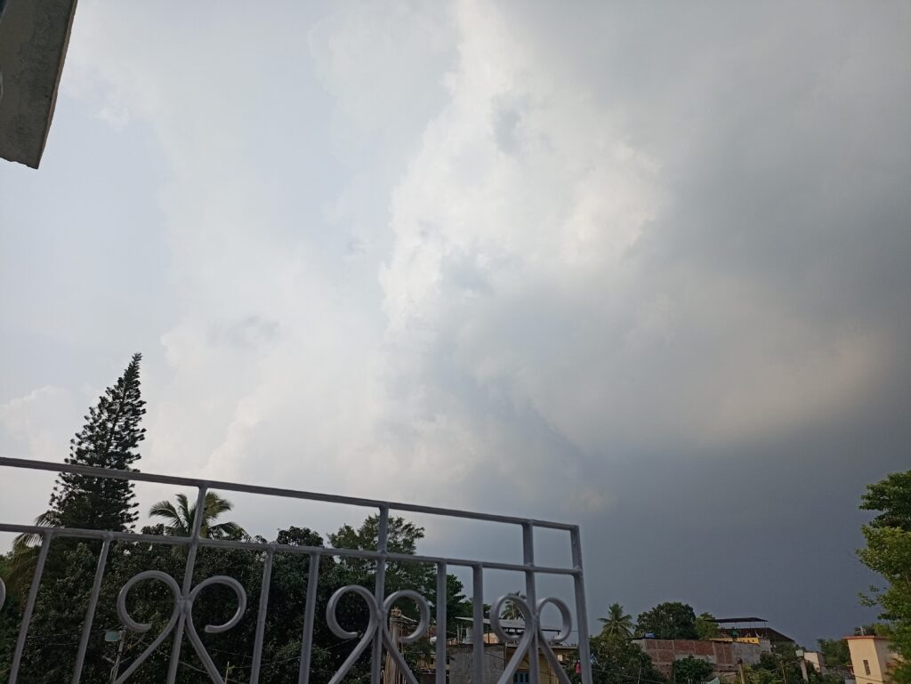 Silver-lined monsoon cloud drifting away after bypassing my rooftop in Birpur.